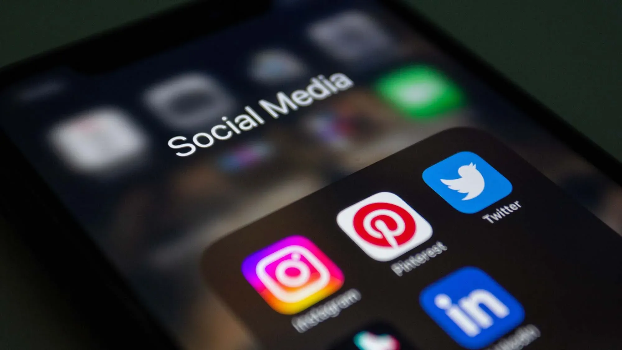 Smartphone displaying social media app icons for business marketing
